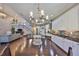 Open-concept kitchen features a center island, stainless appliances, granite counters, and hardwood floors at 6640 Park Strand Dr, Apollo Beach, FL 33572