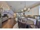 Open-concept kitchen features a center island, stainless appliances, granite counters, and hardwood floors at 6640 Park Strand Dr, Apollo Beach, FL 33572