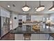 Gourmet kitchen features a center island, stainless appliances, granite counters, and hardwood floors at 6640 Park Strand Dr, Apollo Beach, FL 33572