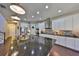 Gourmet kitchen features a center island, stainless appliances, granite counters, and hardwood floors at 6640 Park Strand Dr, Apollo Beach, FL 33572