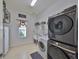 Well-lit laundry room with modern washer/dryer, ample storage, and a convenient utility sink at 6640 Park Strand Dr, Apollo Beach, FL 33572