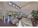 Bright living room features high ceilings, hardwood floors, and glass doors to the patio offering seamless indoor-outdoor living at 6640 Park Strand Dr, Apollo Beach, FL 33572