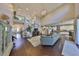 Open-concept living room with beautiful wood floors, high ceilings, staircase and seamless flow into the kitchen area at 6640 Park Strand Dr, Apollo Beach, FL 33572