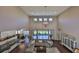 Open-concept living space with high ceilings, hardwood floors, and seamless flow into the kitchen and dining area at 6640 Park Strand Dr, Apollo Beach, FL 33572