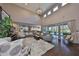 Open living area features high ceilings, hardwood floors, and sliding doors offering abundant light and views of the lanai at 6640 Park Strand Dr, Apollo Beach, FL 33572
