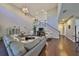 Spacious living room features soaring ceilings, hardwood floors, elegant chandelier and staircase to the upper level at 6640 Park Strand Dr, Apollo Beach, FL 33572
