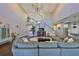 Bright living room with hardwood floors, vaulted ceilings, a modern chandelier, and stairway to the second floor at 6640 Park Strand Dr, Apollo Beach, FL 33572