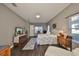 Spacious bedroom with hardwood floors, neutral walls, and an abundance of natural light at 6640 Park Strand Dr, Apollo Beach, FL 33572
