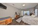 Bright bedroom with hardwood floors, neutral walls, and an abundance of natural light at 6640 Park Strand Dr, Apollo Beach, FL 33572