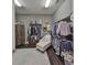 Spacious walk-in closet with custom shelving, hanging racks, a chaise lounge, and wood flooring at 6640 Park Strand Dr, Apollo Beach, FL 33572
