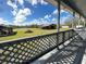 Back porch of the house overlooking a large backyard with a pond and outbuildings at 7705 W Four Pines Rd, Plant City, FL 33565