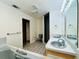 Bathroom featuring double sinks, walk-in shower, built-in tub and neutral color scheme at 7705 W Four Pines Rd, Plant City, FL 33565