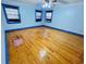 Light blue bedroom featuring hardwood floors, ceiling fan, and bright windows at 7705 W Four Pines Rd, Plant City, FL 33565