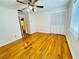Bedroom with hardwood floors, closet, ceiling fan, and a bright window at 7705 W Four Pines Rd, Plant City, FL 33565