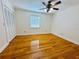 Bedroom with hardwood floors, large closet, ceiling fan, and a bright window at 7705 W Four Pines Rd, Plant City, FL 33565