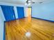 Light blue bedroom featuring hardwood floors, ceiling fan, and double closets at 7705 W Four Pines Rd, Plant City, FL 33565