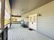 Welcoming covered porch with chairs and ample space, perfect for outdoor seating at 7705 W Four Pines Rd, Plant City, FL 33565