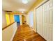 Hallway boasts gleaming hardwood floors, with multiple doors leading to different rooms at 7705 W Four Pines Rd, Plant City, FL 33565