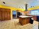 Well-equipped kitchen with ample cabinetry, center island and stainless steel appliances at 7705 W Four Pines Rd, Plant City, FL 33565