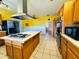 Functional kitchen featuring an island cooktop, ample storage, and stainless steel appliances at 7705 W Four Pines Rd, Plant City, FL 33565