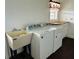 Laundry room includes a utility sink with a washer and dryer at 7705 W Four Pines Rd, Plant City, FL 33565