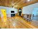 Cozy living room with a fireplace, wood paneling and hardwood floors at 7705 W Four Pines Rd, Plant City, FL 33565