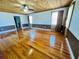 Large living room features hardwood floors, a wooden ceiling, and windows providing natural light at 7705 W Four Pines Rd, Plant City, FL 33565