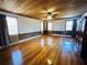 Bright living room with hardwood floors, wooden ceiling, and large windows with lots of natural light at 7705 W Four Pines Rd, Plant City, FL 33565