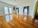 Bright living room featuring hardwood floors, neutral walls, and natural light from windows and french doors at 7705 W Four Pines Rd, Plant City, FL 33565