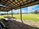 Covered picnic shelter with a picnic table and benches overlooking the pond at 7705 W Four Pines Rd, Plant City, FL 33565