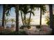 Inviting outdoor patio with wicker seating, lush greenery, and stunning ocean views at 805 S Gulfview Blvd # 305B, Clearwater, FL 33767