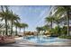 Luxurious swimming pool surrounded by palm trees and lounge chairs at a beachfront resort at 805 S Gulfview Blvd # 305B, Clearwater, FL 33767