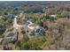 Aerial view showcasing a beautiful property surrounded by lush trees, featuring solar panels at 9911 Mendel Dr, New Port Richey, FL 34654