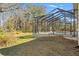 Backyard view of a screened in-ground pool and mature trees at 9911 Mendel Dr, New Port Richey, FL 34654