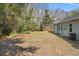 View of the grassy backyard and back of the home at 9911 Mendel Dr, New Port Richey, FL 34654