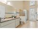 Bathroom features a walk-in shower, toilet, sink and a door leading to an outdoor area at 9911 Mendel Dr, New Port Richey, FL 34654