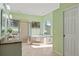 Bright bathroom featuring a soaking tub, glass enclosed shower, and double sink vanity at 9911 Mendel Dr, New Port Richey, FL 34654