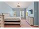 Bedroom with a bed, TV, and dresser against a calming blue backdrop at 9911 Mendel Dr, New Port Richey, FL 34654