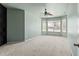 Spacious carpeted bedroom with a ceiling fan and multiple windows at 9911 Mendel Dr, New Port Richey, FL 34654