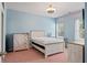 Cozy bedroom with natural light, decorated with a rustic white furniture set and a bed at 9911 Mendel Dr, New Port Richey, FL 34654