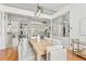 Elegant dining area featuring modern light fixtures, a spacious table with comfortable seating, and hardwood floors at 9911 Mendel Dr, New Port Richey, FL 34654