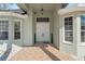Elegant front entrance featuring double doors, decorative columns, and well-manicured landscaping at 9911 Mendel Dr, New Port Richey, FL 34654