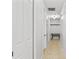 Long hallway with neutral tile flooring and a white wall color at 9911 Mendel Dr, New Port Richey, FL 34654