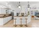 Open concept kitchen with island and bar seating overlooking other living areas at 9911 Mendel Dr, New Port Richey, FL 34654