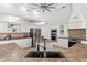 Close up of the kitchen and island with seating; stainless steel appliances and white cabinetry throughout at 9911 Mendel Dr, New Port Richey, FL 34654