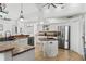 Bright kitchen with stainless steel appliances, ample cabinet space, and island with sink at 9911 Mendel Dr, New Port Richey, FL 34654