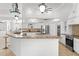 Spacious kitchen featuring a breakfast bar, stainless steel appliances, and ample counter space at 9911 Mendel Dr, New Port Richey, FL 34654