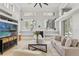 Bright living room with large windows, built-in shelving, and a cozy fireplace at 9911 Mendel Dr, New Port Richey, FL 34654