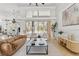 Bright living room features high ceilings, neutral decor, and sliding glass doors to the outdoor pool area at 9911 Mendel Dr, New Port Richey, FL 34654