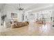 Open-concept living room with tile flooring, neutral walls, high ceilings, and stylish furnishings for a modern aesthetic at 9911 Mendel Dr, New Port Richey, FL 34654
